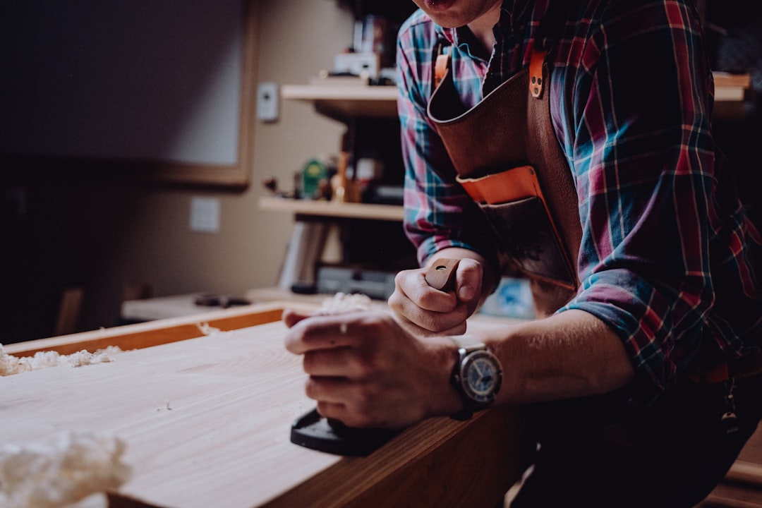 Woodworker handling lumber in a workshop