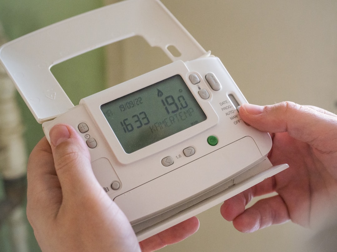 Person using a device to monitor home energy use