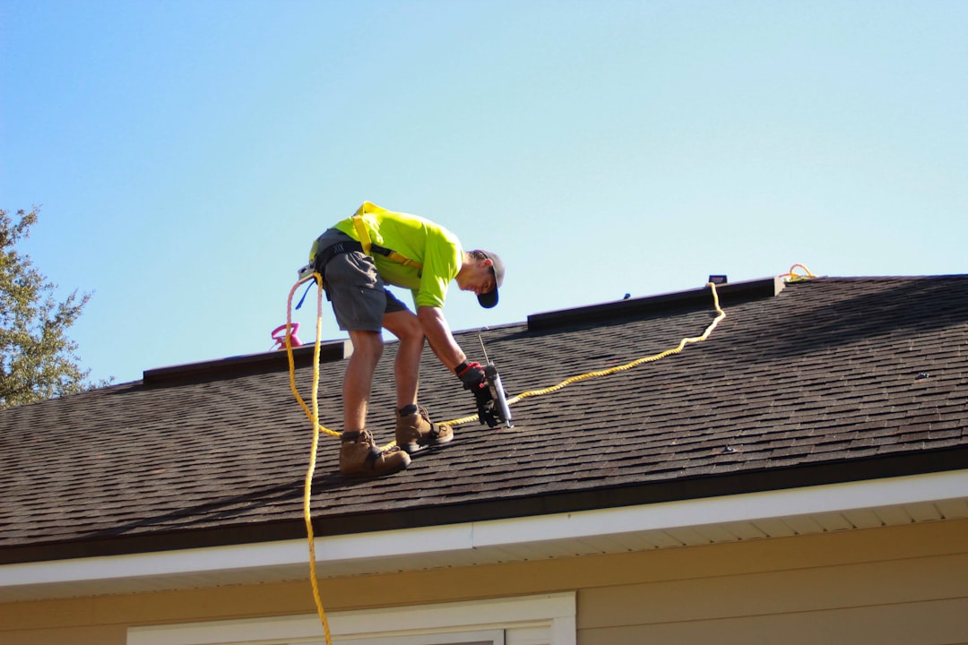 Worker installing materials on a residential roof